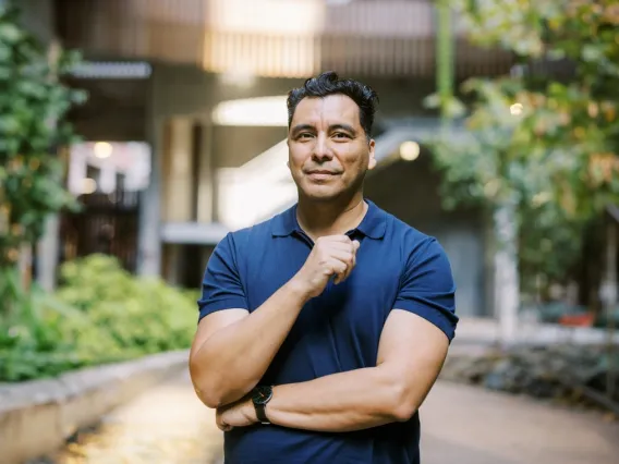Manuel Muñoz standing with arms folded