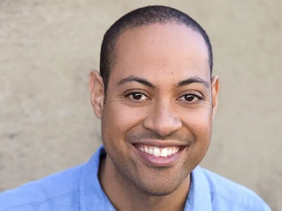 Corey Roberts in a blue shirt, smiling
