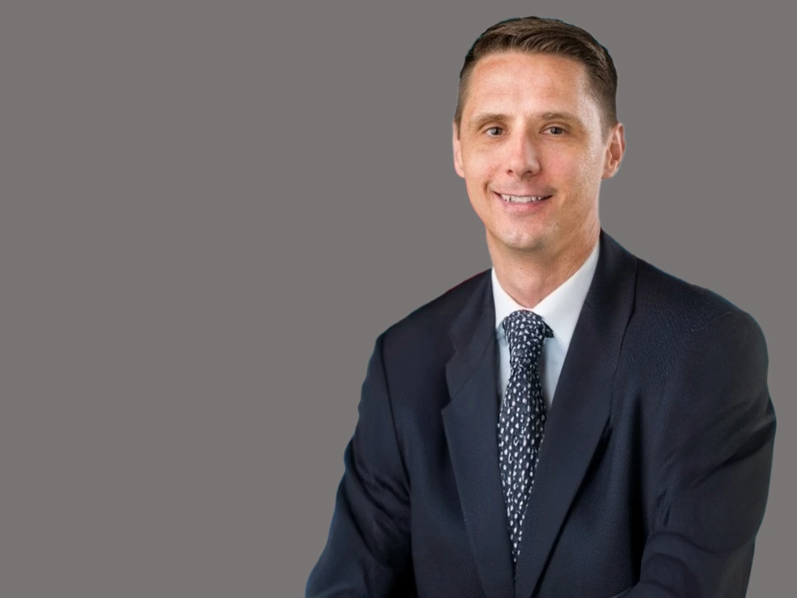 Man with brown hair and black suit