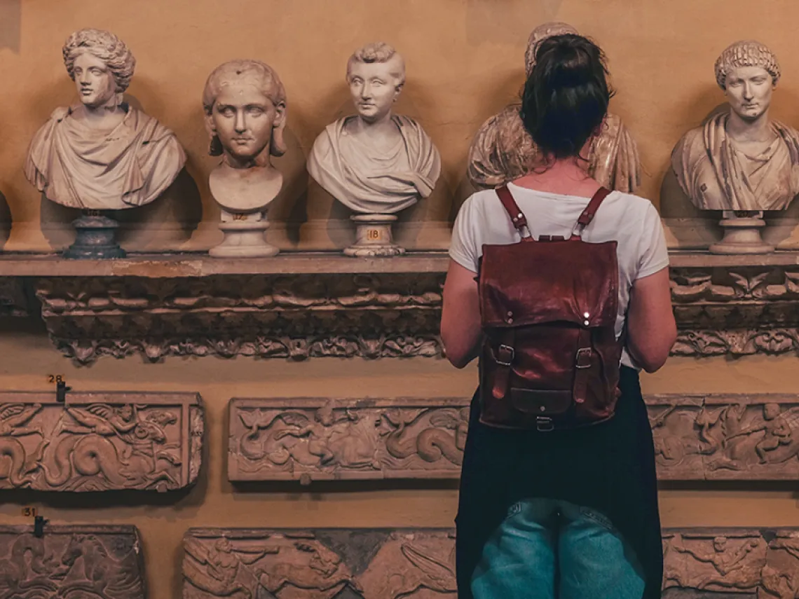 young woman looking statues