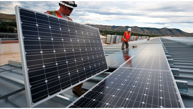 photo of people installing solar panels