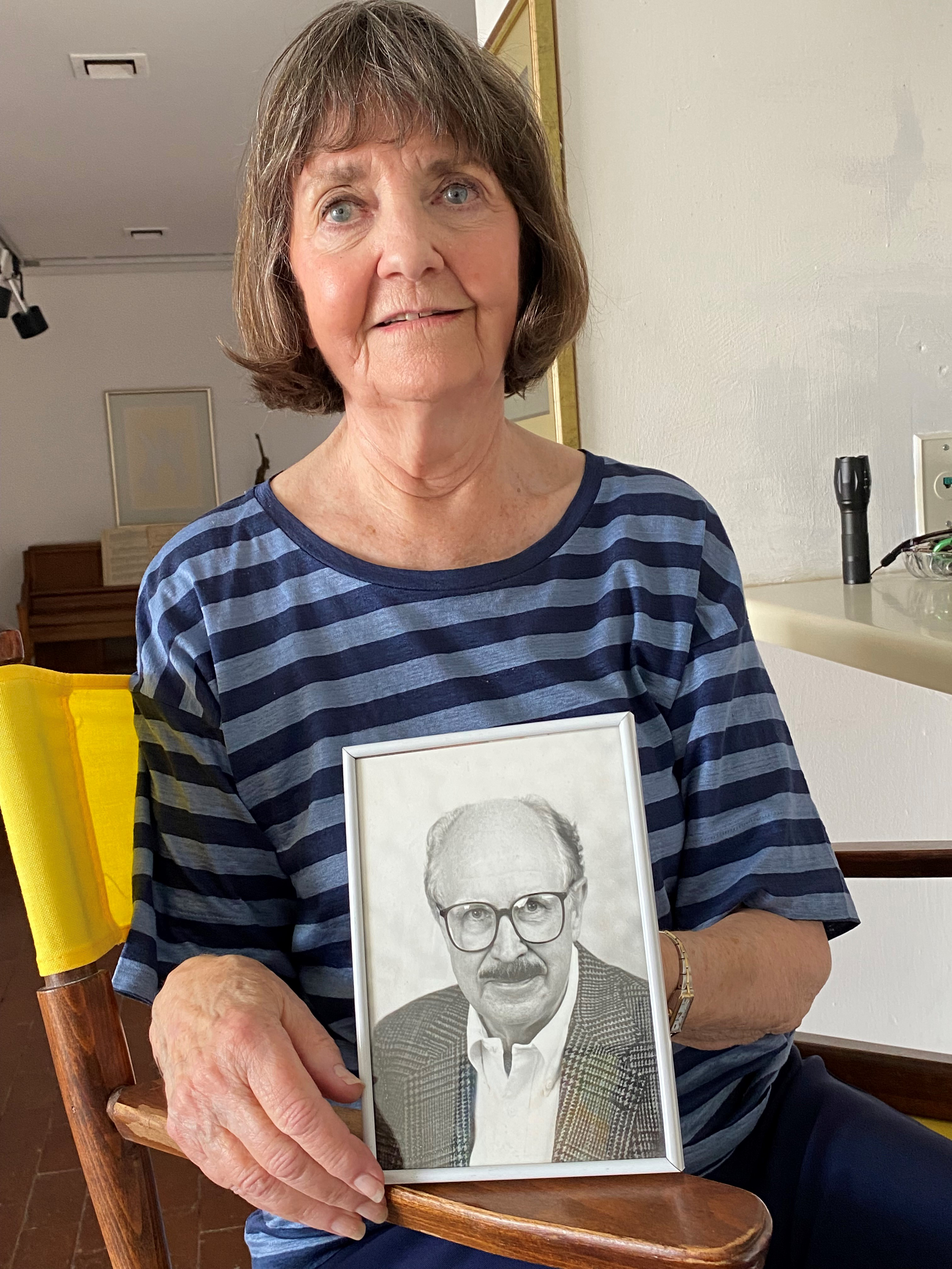 June Webb-Vignery holds a photo of her late husband, Bob Vignery.