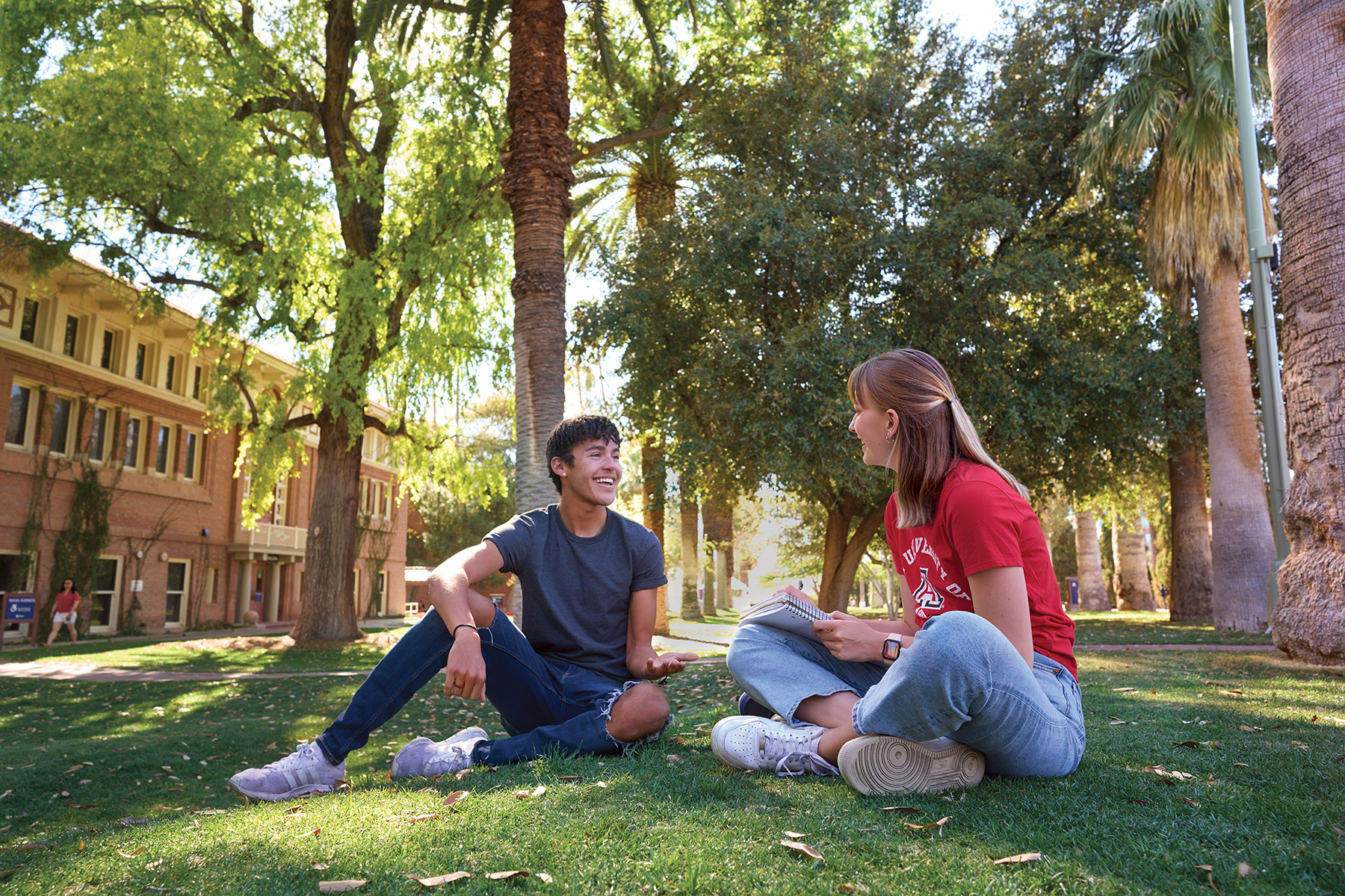 two University of Arizona students in front of Douglass building