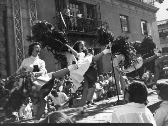 University of Arizona cheerleaders perform during a 1952 pep rally outside the Pioneer building in downtown Tucson.