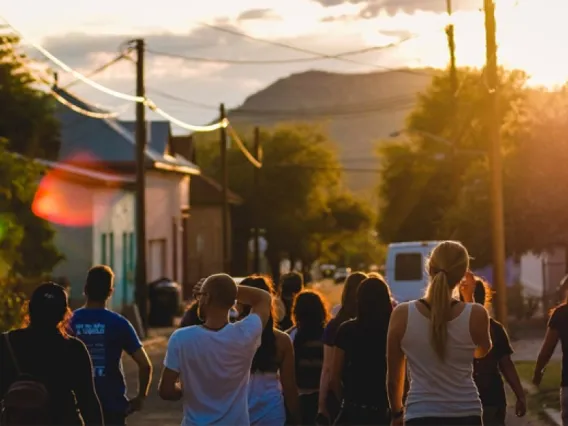 the backs of a group of young people in the street