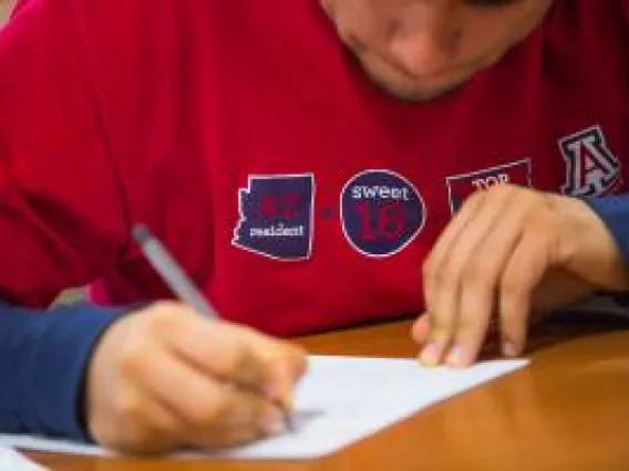 Student writing on a piece of paper