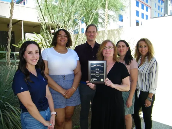 SIROW team with holding award for their work