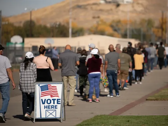 People standing in line outside, waiting to vote