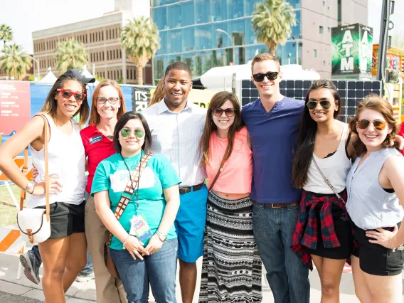 Group of alumni posing together outdoors