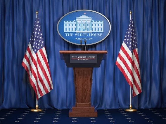 The White House press room, with two American flags flanking the podium