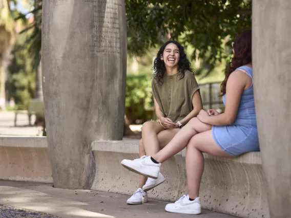 two women sitting at the Women's Plaza of Honor