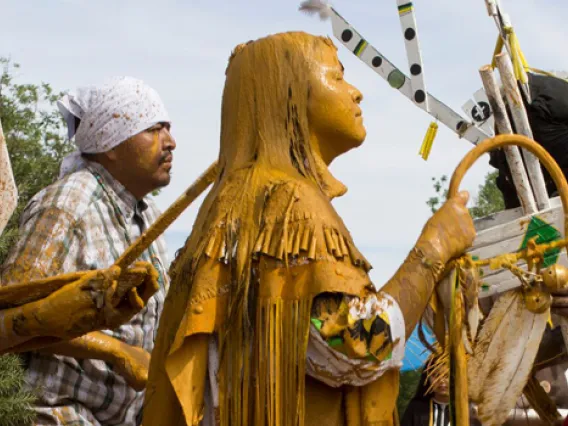 mand and goldern statue of women during a processional