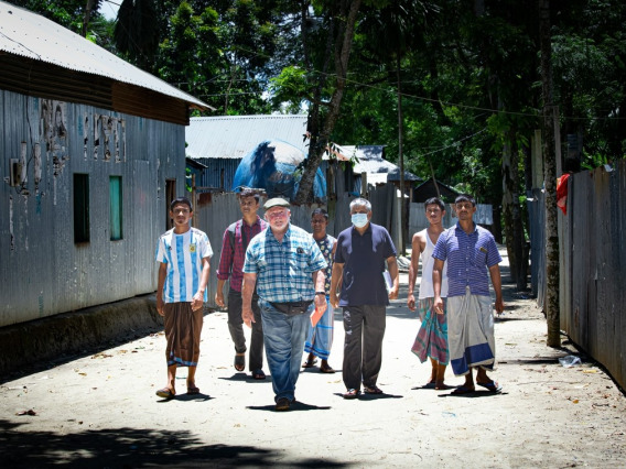 Tim Finan walks the streets of Bangladesh with six people