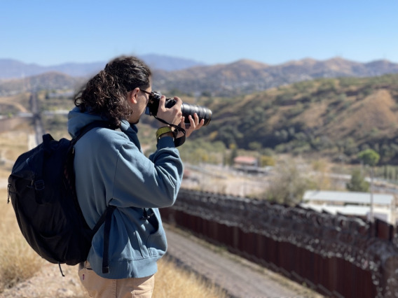 A University of Arizona journalism student takes pictures during a border reporting field trip to the U.S.-Mexico border.