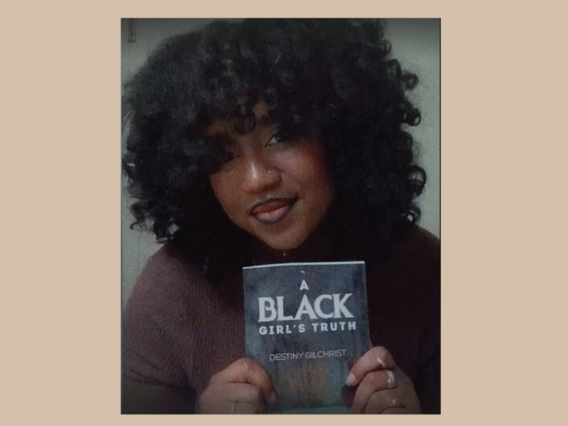 Destiny Gilchrist holding book A Black Girls Truth