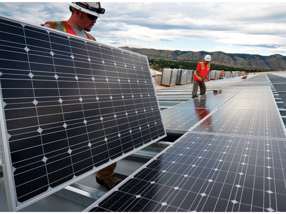 photo of people installing solar panels