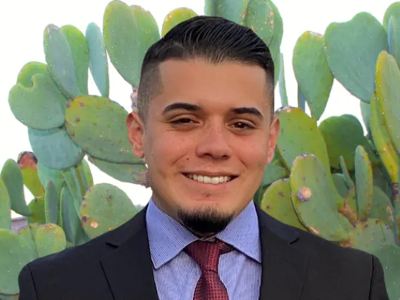 Patrick Robles in front of cacti