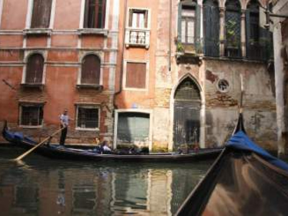 Gondola on canal between buildings in Italy