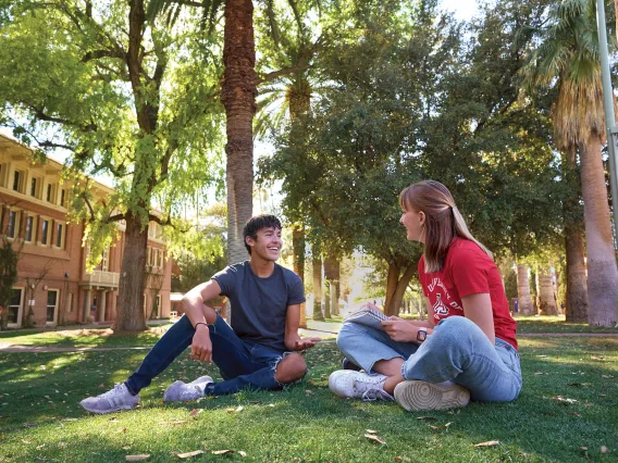 two University of Arizona students in front of Douglass building