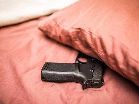 Gun in bed under pillow