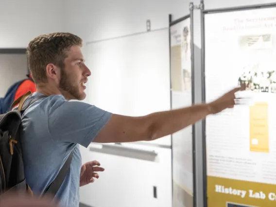 Student interacting with history exhibit