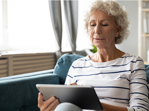 older women holding laptop