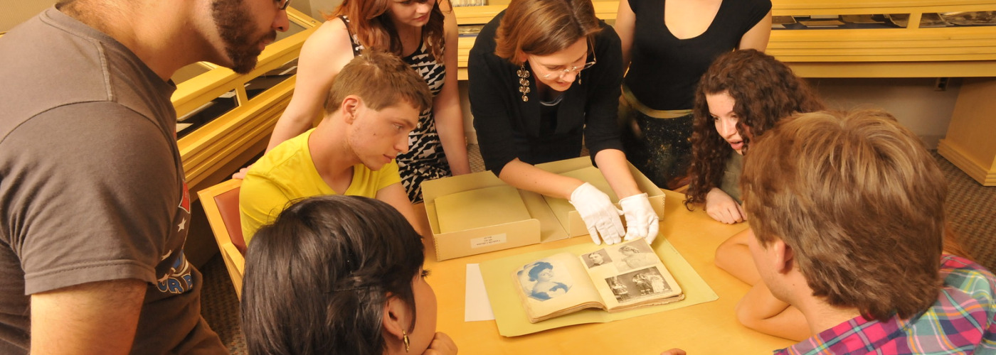 Students in a history class looking at archival materials