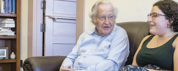 Graduate student chatting with UA Professor Noam Chomsky