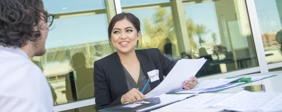 Female student in business suit at interview