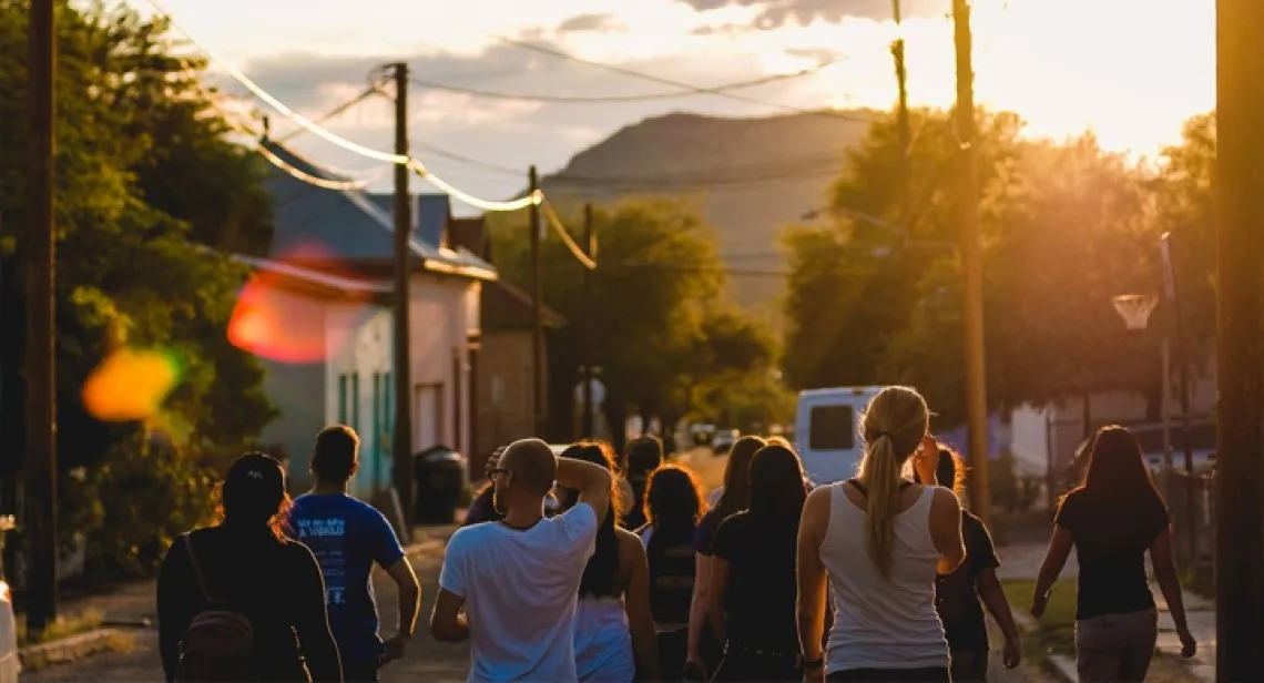 the backs of a group of young people in the street