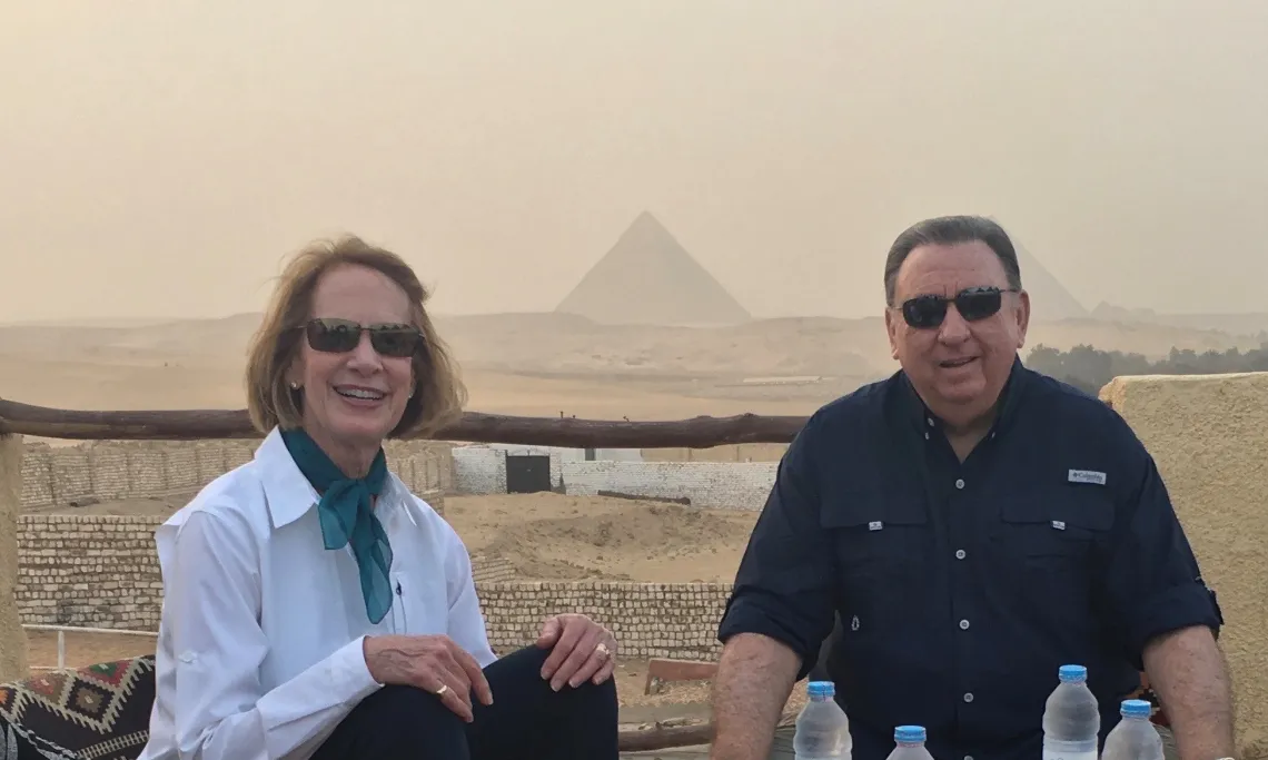 Nancy and Steve Lynn sitting in front of the pyramids