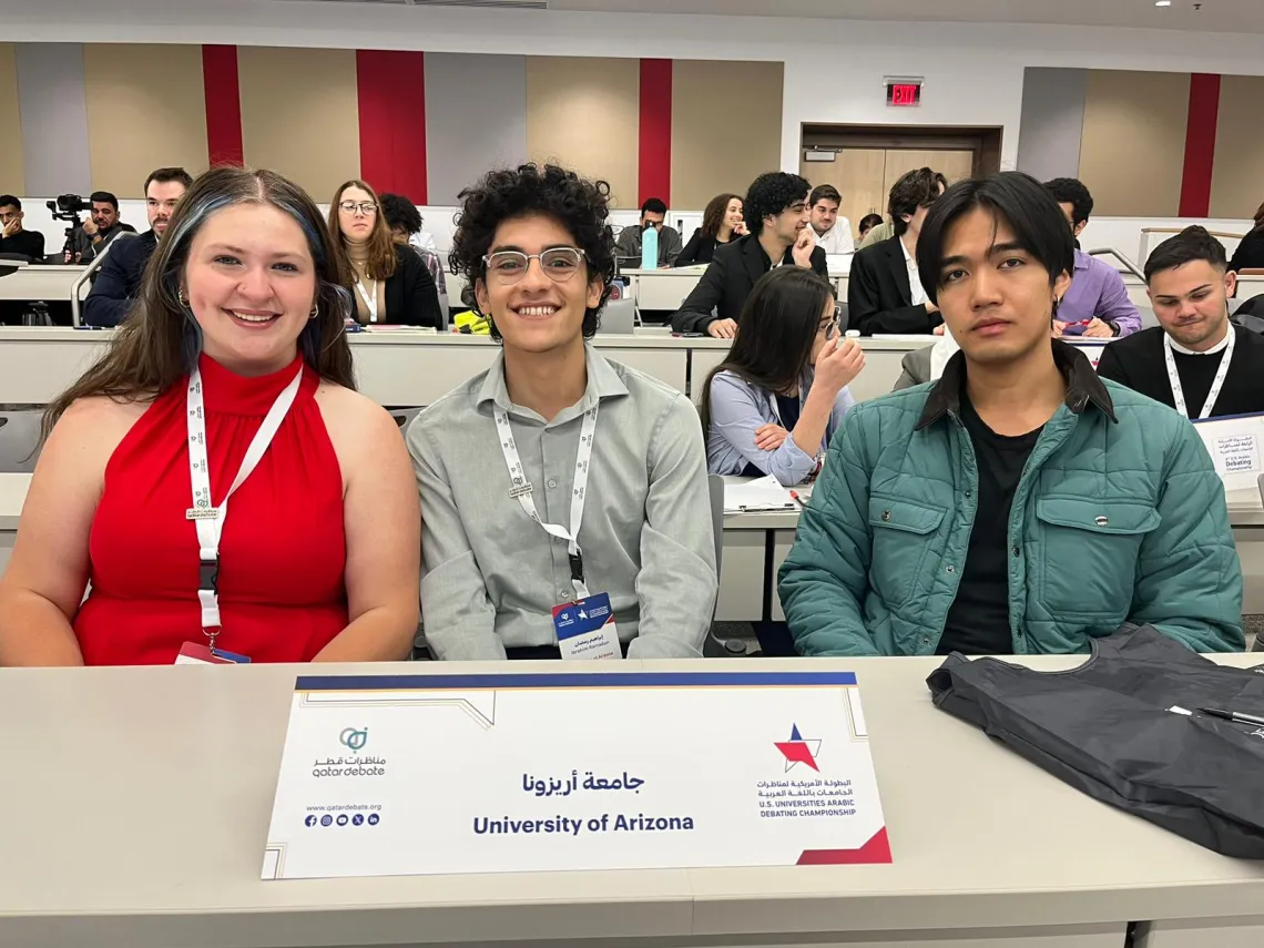 Mackenzie Rice, Ibrahim Ramadan, and Yin Qin sitting at a table