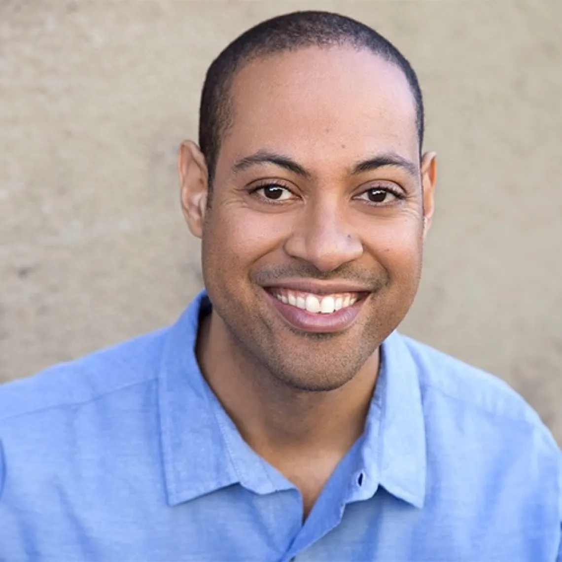 Corey Roberts in a blue shirt, smiling