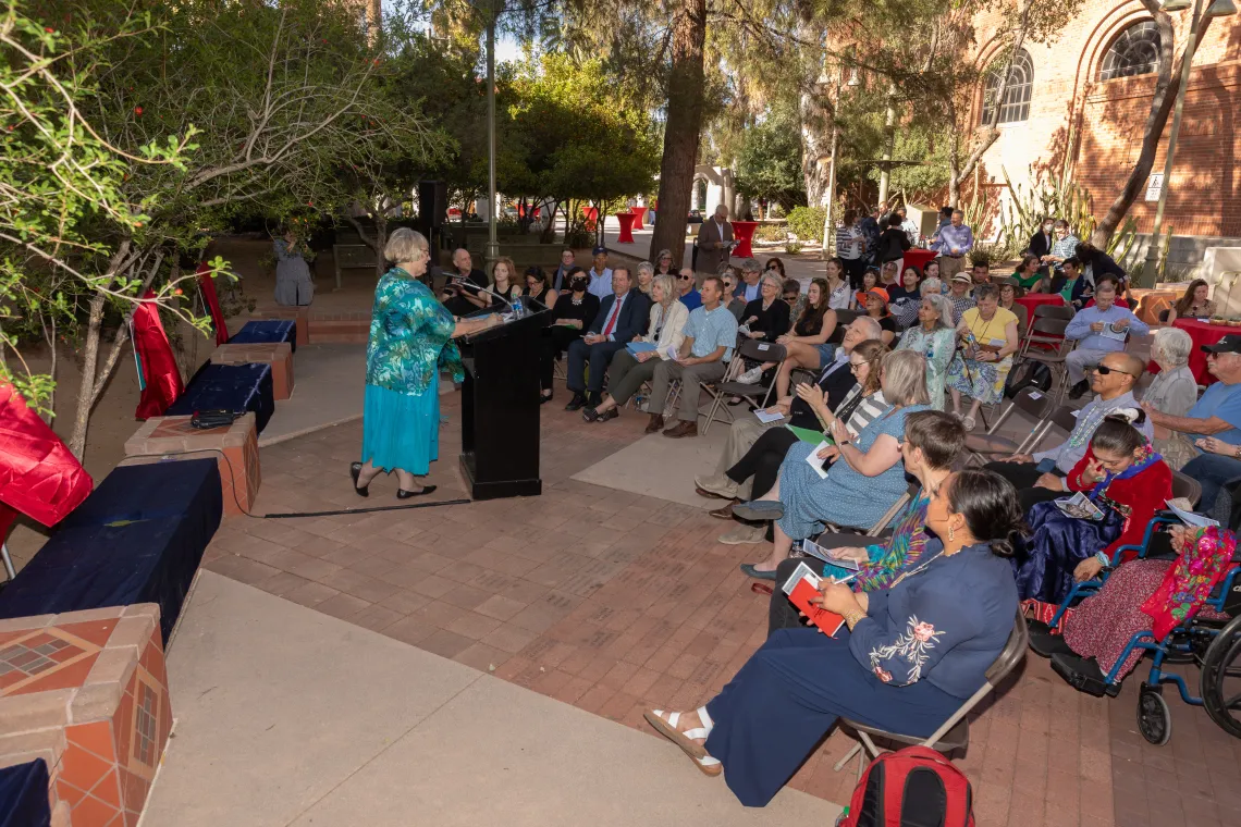 Mary Grier speaking in front of a group at the Womens Plaza of Honor