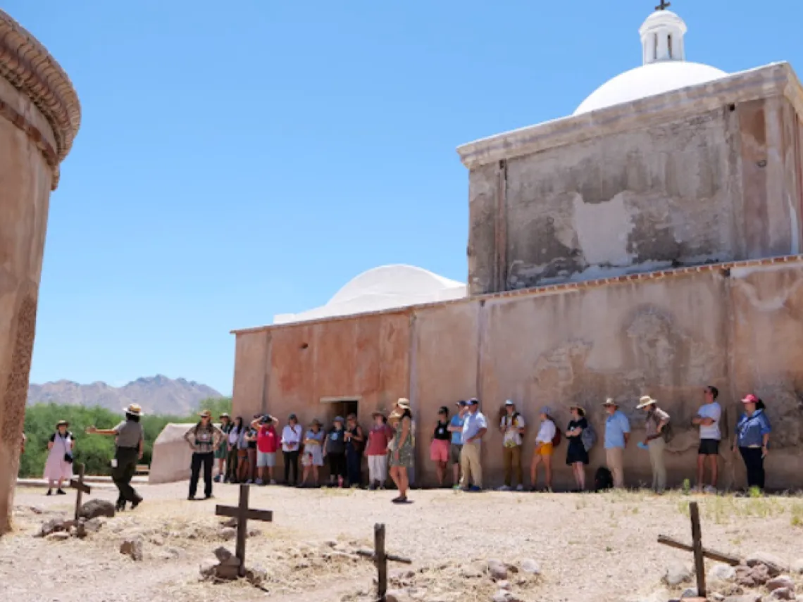 people in front of Tumacácori National Historic Park