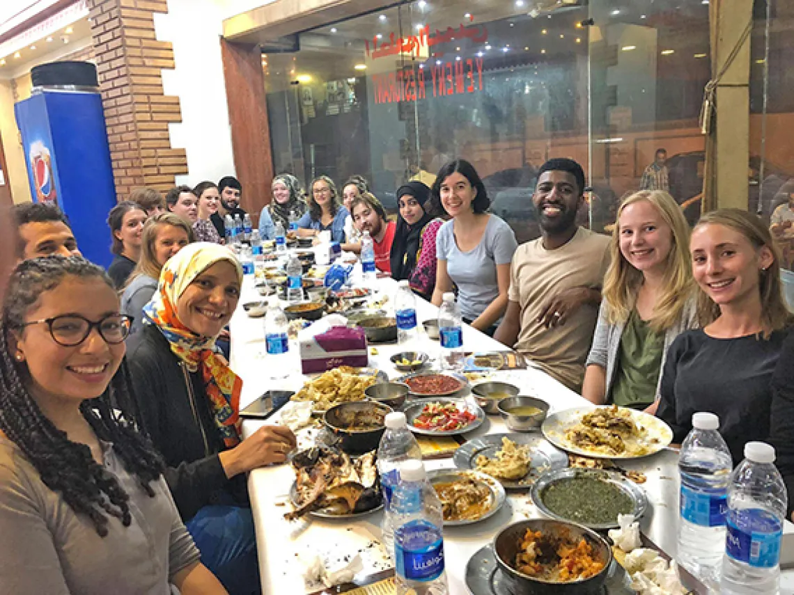 Students at large table sharing meal