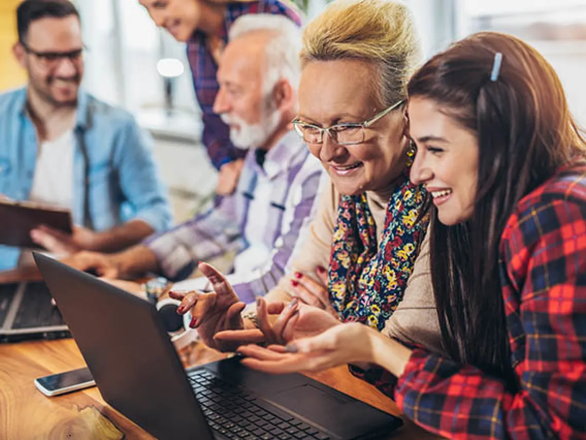 group of people looking at a computer