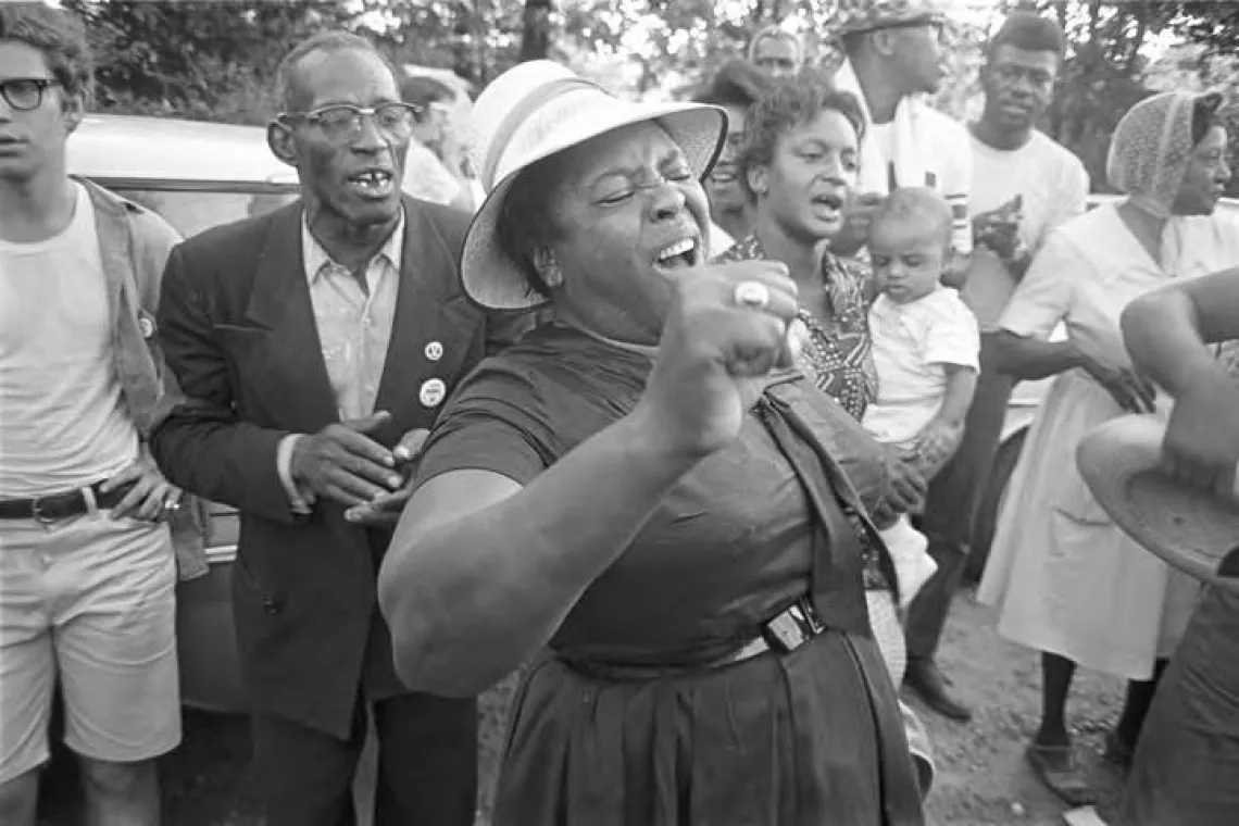 Fannie Lou Hamer singing to a group of people