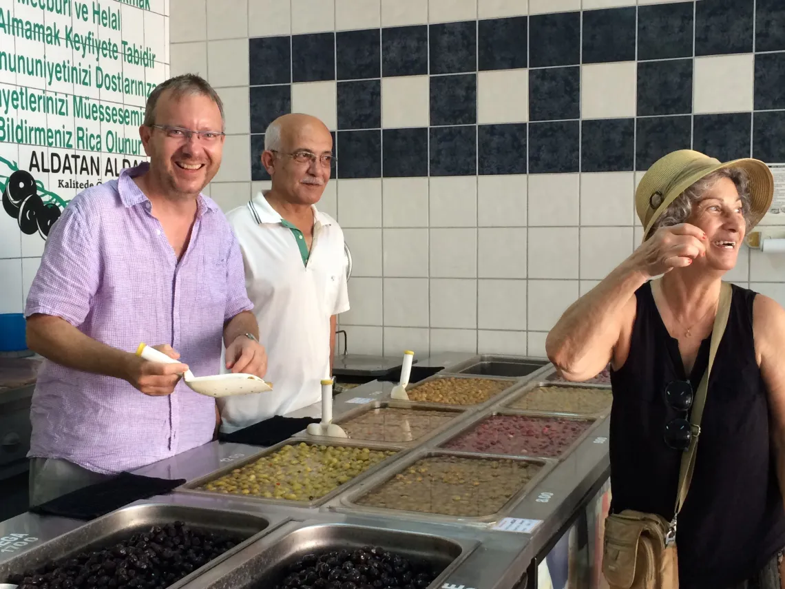 Brian Silverstine in Turkey ladeling soup with two other people