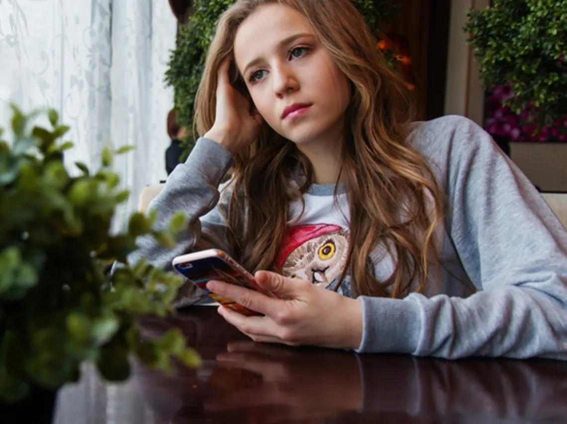 young woman holding smartphone