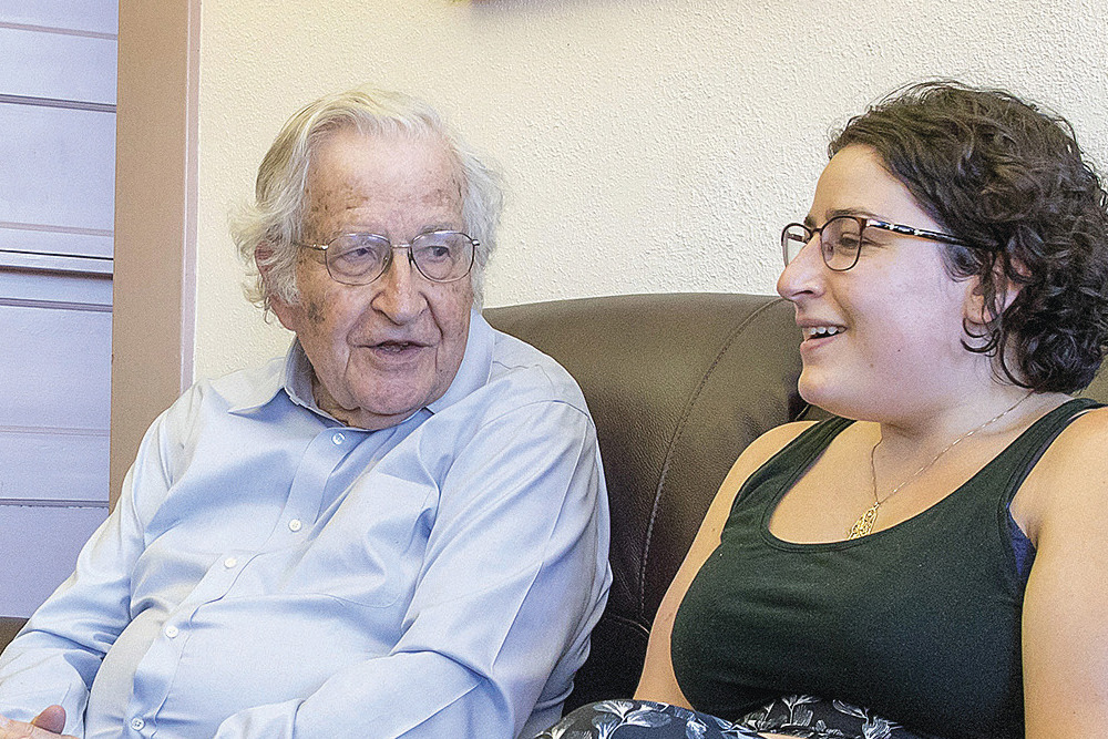 Graduate student chatting with UA Professor Noam Chomsky