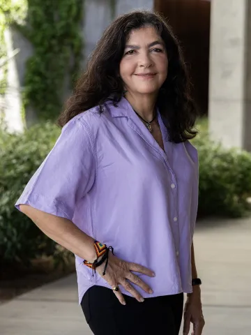 Woman with brown hair in a purple blouse