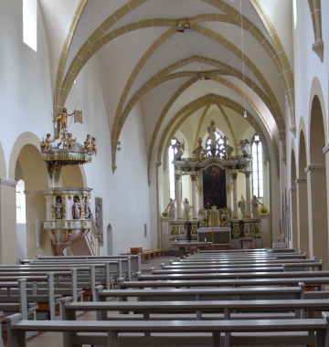 inside of a white church with high arches