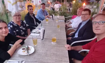 seven people at a table drinking beverages