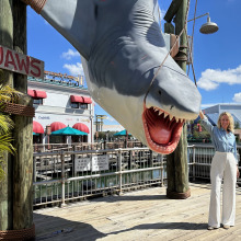 Woman standing next to Jaws fake shark