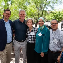 Group of five people standing outside for a photo