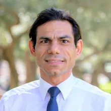 A man with a white shirt and blue tie