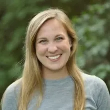 Woman with long blonde hair and a grey sweater