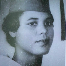 Black and white photo of a woman in a graduation picture