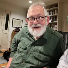 John Collinge in his study